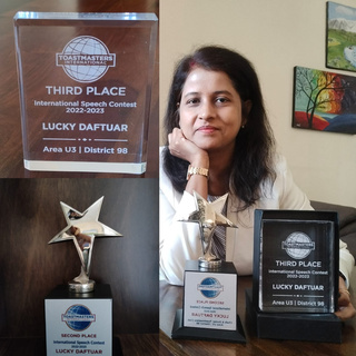 Lucky Daftuar with third-place trophies from a speaking competition